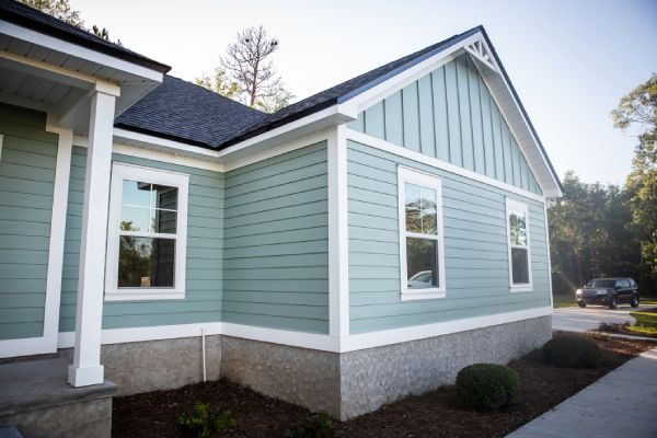 A house with new grey siding and a new roof.